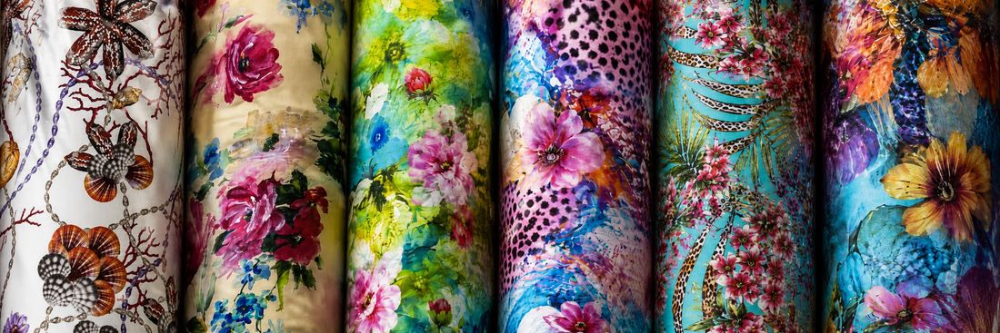 Fabrics — rolled bolts of printed fabric in assorted patterns